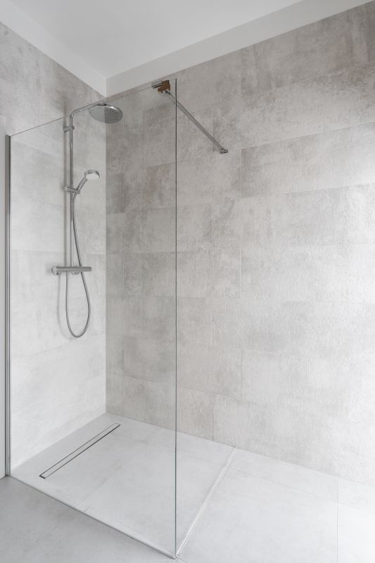Renovated bathroom with rainfall showerhead and glass enclosure